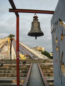 The "Bell of Peace," situated in front of the Hoxha pyramid, was cast from discarded shell casings from the 1997 turmoil