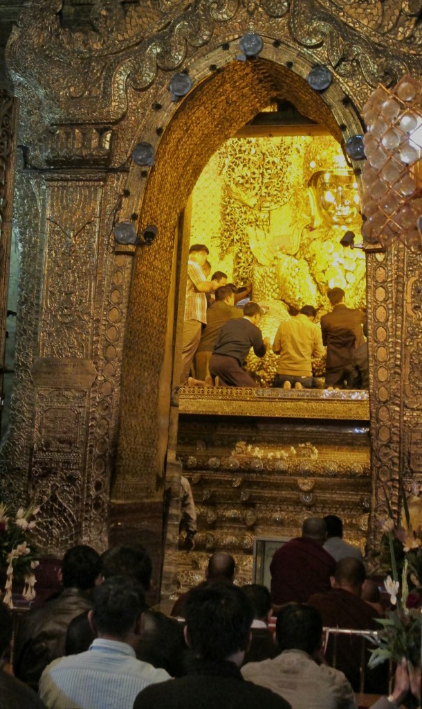 Males applying gold leaf